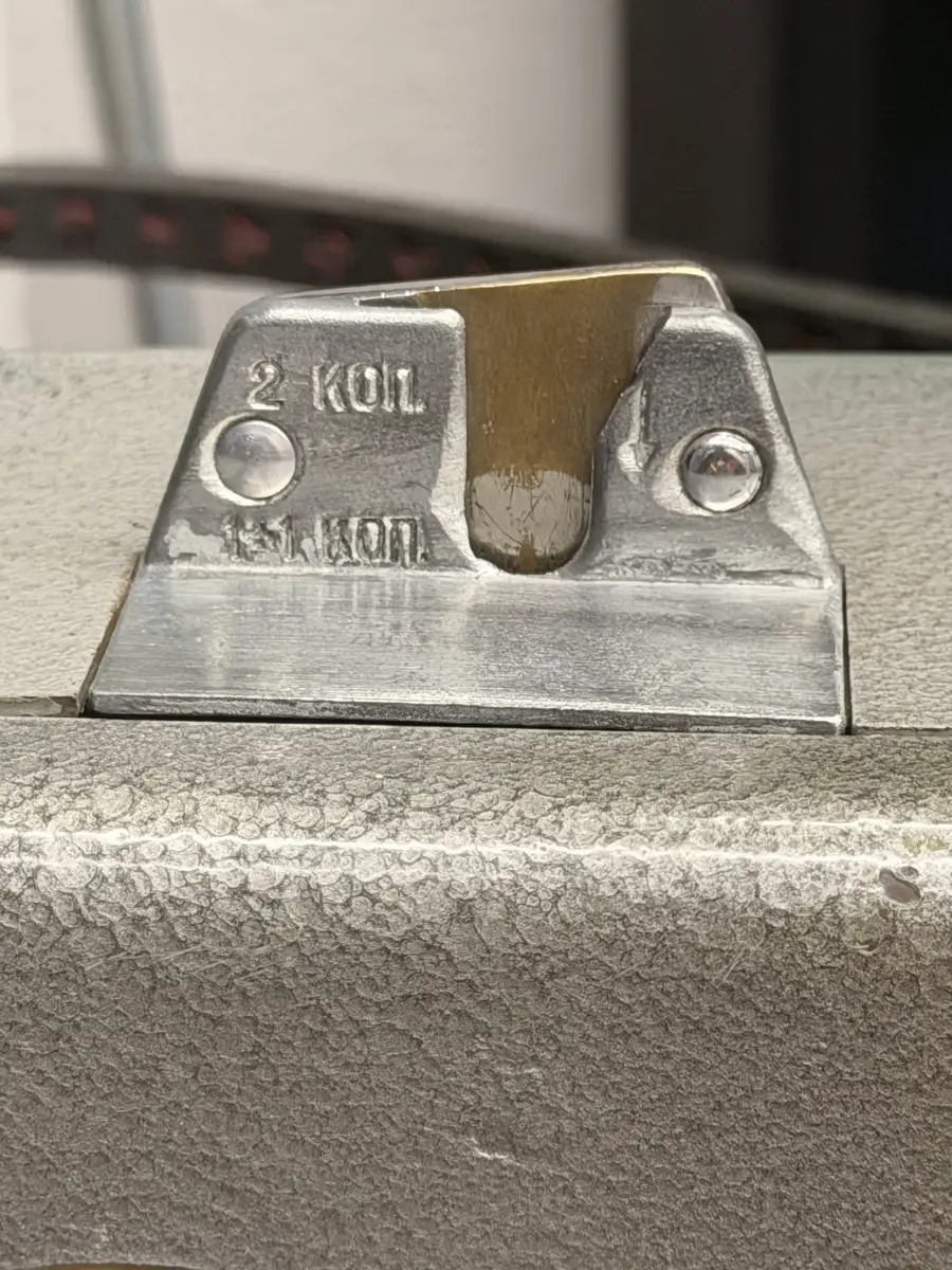 The cast aluminium coin slot, marked 2 КОП and 15 КОП.
