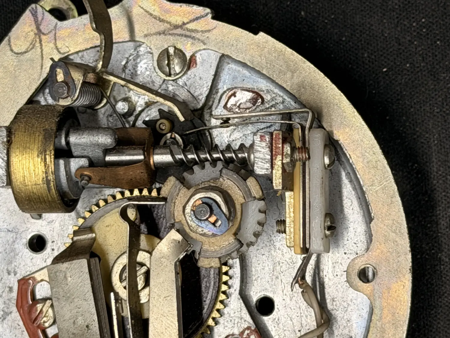 Close-up of the rotary dial's brass and steel gear mechanism.